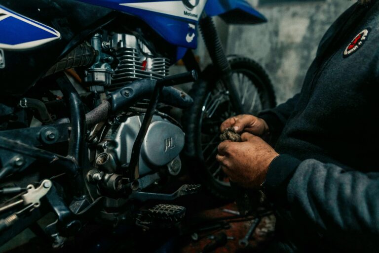 A man working on a motorcycle in a garage